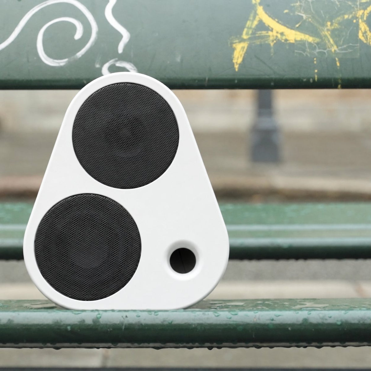 White ES2 on a green bench in front of a graffiti-covered wall #color_white